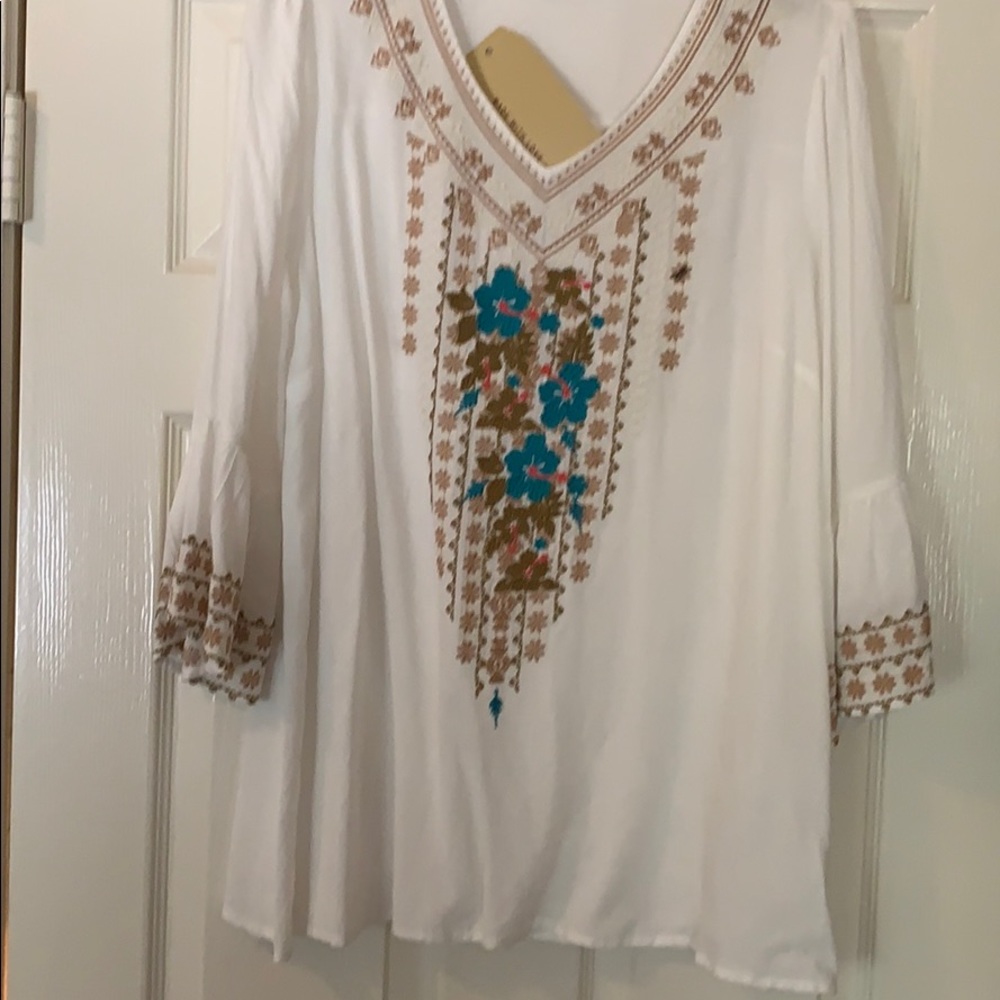 A white blouse with embroidery in the front